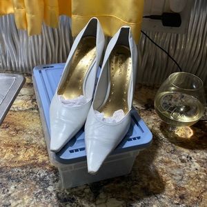 White pointed toe leather pumps 3 inch heels a little wear on the left toe